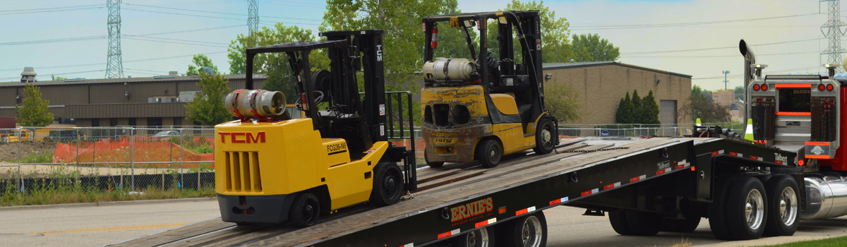 A forklift being transported from a forklift dealer.