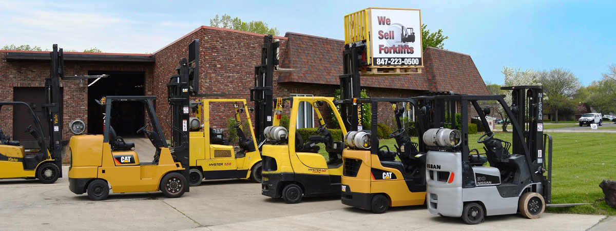 A group of used forklifts for sale.