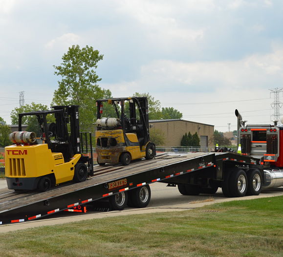 Forklifts being transported from Advantage Material Handling, scissor lift rental options available.